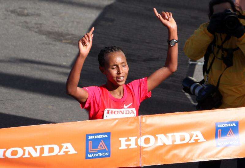 Fatuma Sado of Ethiopia throws her hands in the air as she crosses the finish line at the 2012 Honda LA Marathon.
Fatuma beat her personal best by more than two minutes and won the $100,000 gender challenge bonus.
Photo by &amp;lt;a