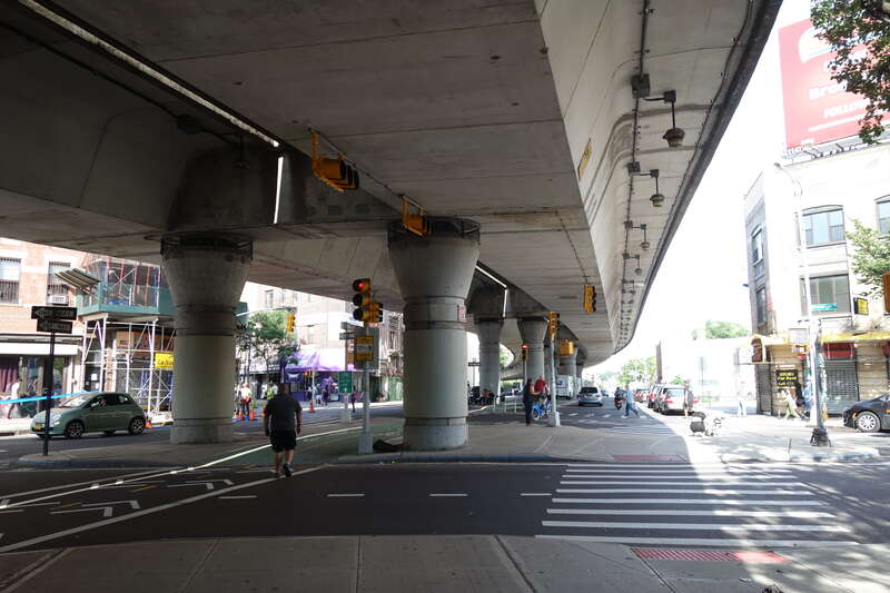 Looking from LaGuardia Playground South at the elevated highway spur running from the Williamsburg Bridge to the Brooklyn-Queens Expressway, at Havemeyer Street and South 4th Street in Williamsburg, Brooklyn. The highway trestle looks very modern,