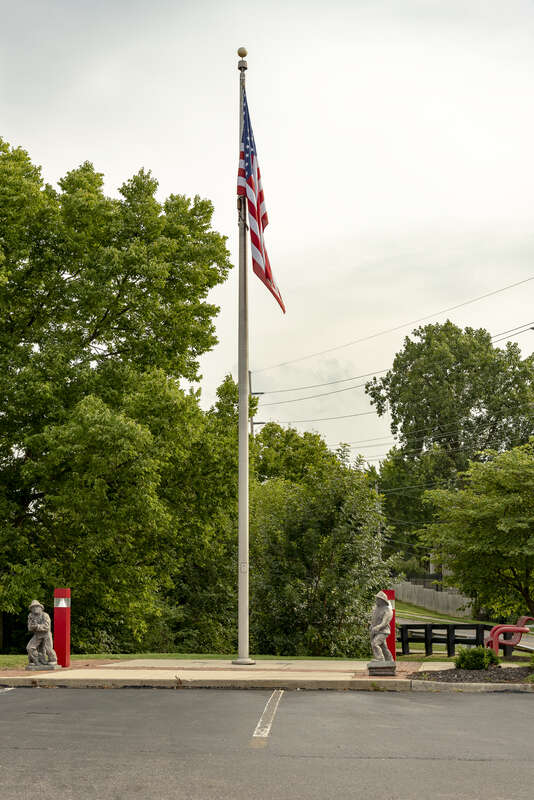 Two small statues at the Jackson Township fire department headquarters on a stormy day.