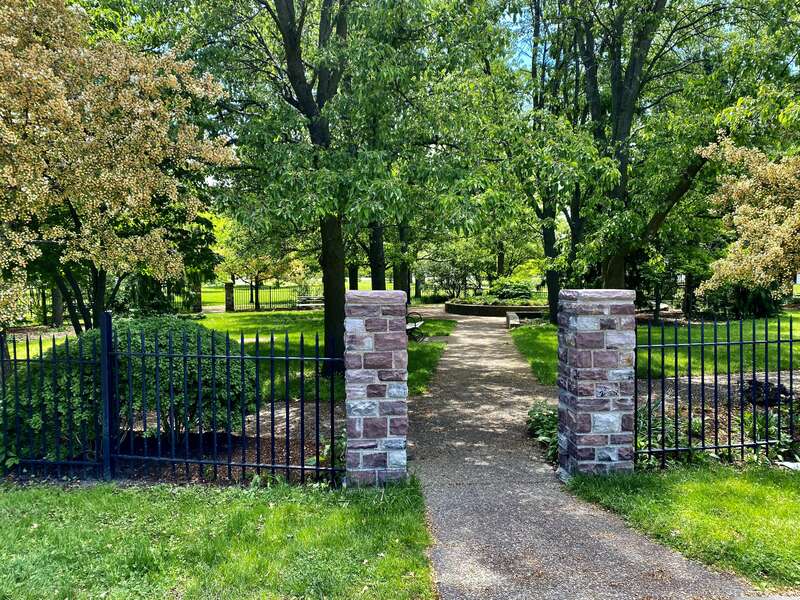 As seen in May 2021: the entrance gate to the "cottage garden" at Martin Luther King, Jr. Park. Tucked away inconspicuously behind the Science Museum, facing the parking lot and the park ring road, the garden was once a much grander entity: its