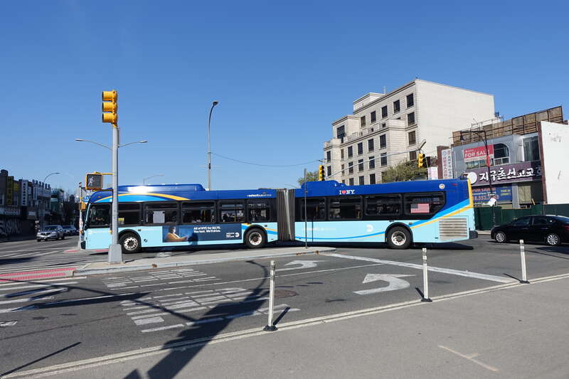 A Jamaica−Merrick Boulevard-bound Q44 SBS bus turning south from Northern Boulevard onto Main Street in Downtown Flushing, Queens.