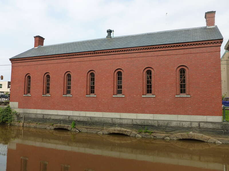 The Moody Street Feeder Gatehouse, built in 1848.  Located on the north side of the intersection of Suffolk Street and Merrimack Street, on the west side of the canal.