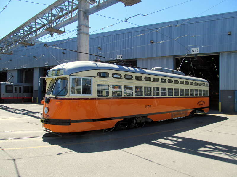 Streetcar #1059 at Muni Metro East in July 2017. When PCC streetcars were first painted in the schemes of other cities, Muni had a limited color palette, and #1059 was painted in a scheme that did not match the actual livery used in Boston. In April