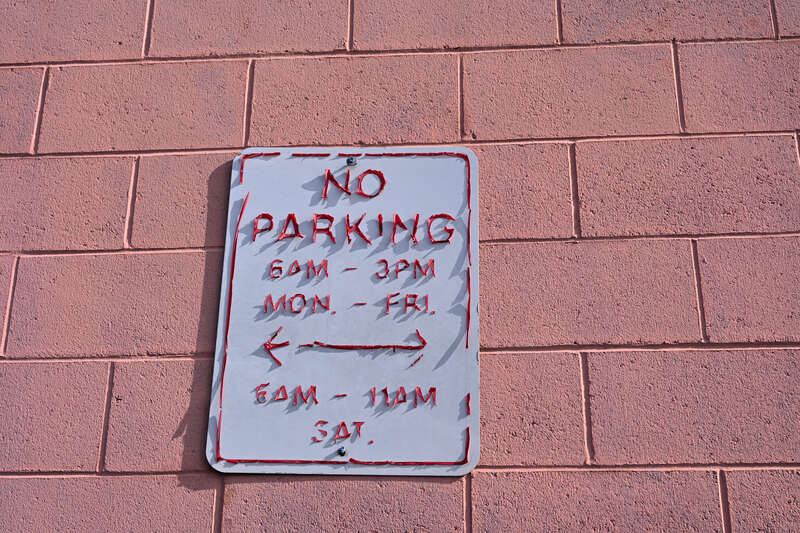 A &quot;no parking&quot; sign at the Market Basket grocery store in Somerville, Massachusetts, with the lettering peeling off