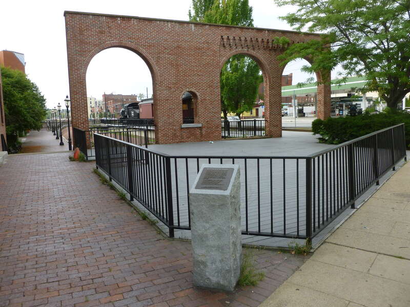 Replica of the front arches of the Merrimack Street depot of the Boston and Maine railroad.  Located on the southeast corner of the intersection of Merrimack Street and Dutton Street in Lowell, Massachusetts.