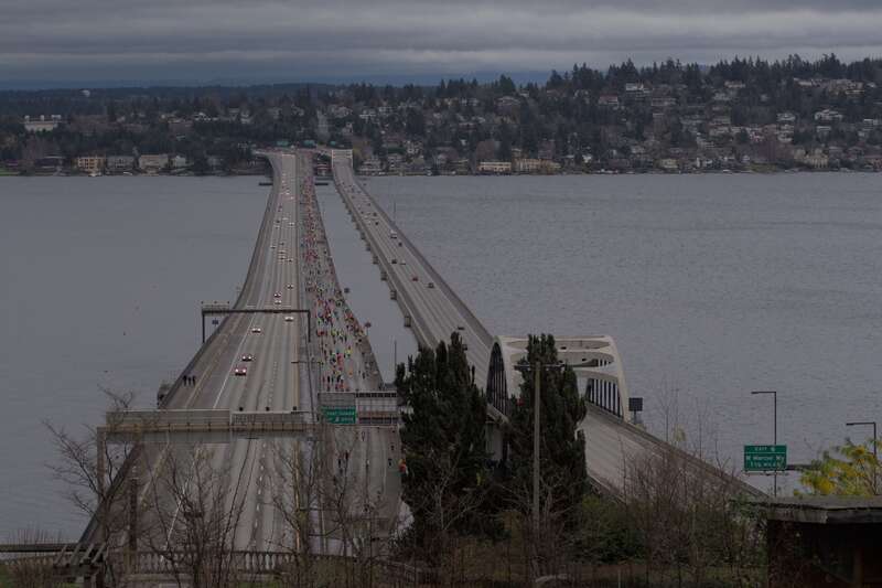 View from the East Portal Viewpoint of runners in the Seattle Marathon running along Interstate 90 on the Homer M. Hadley Memorial Bridge over Lake Washington
