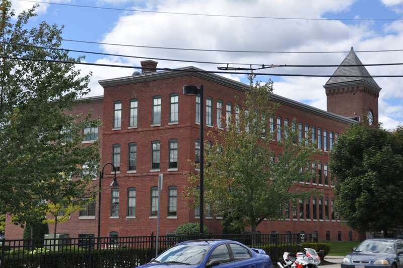 A photograph of the historic United States Watch Company building in Waltham, Massachusetts.
