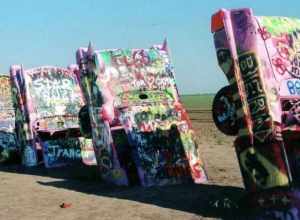 (1 in a multiple picture set)
A closer view of Cadillac Ranch along old Rt. 66 west of Amarillo. While we were they a film crew frm a local station was making a documentary and asked to interview us.  We found magic markers left at the site and added