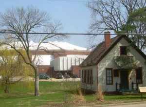 The historic one-room Eyestone School with Redbird Arena in the background on the campus of Illinois State University, Normal, Illinois. Originally the Rose Hill School, this building was moved to this location in 1965 and rededicated to the memory