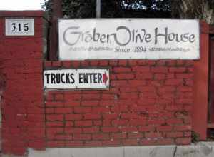 Photo of the signage in front of the Graber Olive House, 315 E 4th St, Ontario, CA 91764. In 1894, two years after planting olive trees in Ontario, California, C. C. Graber began selling vat cured olives. Graber Olive House is the oldest operating