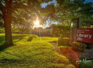 The Summer sun sets over the Grace A Dow Library in Midland MI.