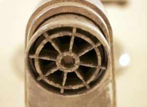 A tub faucet with built-up calcification from hard water in Southern Arizona.