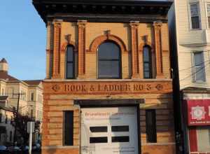 Looking east across Central Avenue at Hook # Ladder No 3 house, late on a sunny day