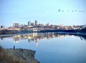 The Kaw Point overlook at Kaw Point Park is in Kansas City, Kansas. It views the land formation point, the confluence of the Kansas River to the right and the Missouri River to the left, and downtown Kansas City, Missouri on the horizon. A family