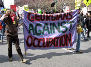 Two people carry a banner reading "Georgians Against Occupation" down South Clark Street in Arlington, Virginia's Crystal City neighborhood.
The March on Crystal City (formally the March on the Pentagon) was a protest against the wars in Iraq and
