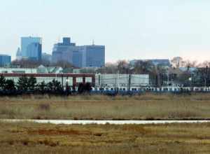 Orient Heights Yard with old 0600 Blue Line stock, with the Boston skyline behind. Taken from Belle Isle Marsh.