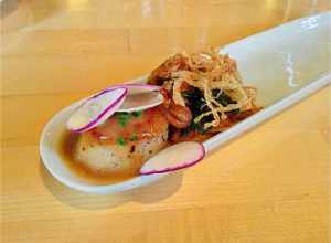 A Prince Edward Island scallop with Korean rice cake with Thai seasonings. Hot and spicy.