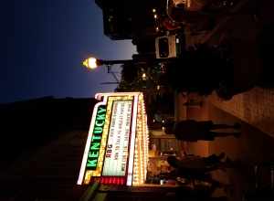 An evening view of Main Street in Lexington, Kentucky, featuring the Kentucky Theater marquee.