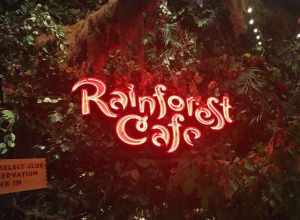 A neon-sign welcomes visitors outside a Rainforest Cafe, located inside the Great Lakes Crossing shopping complex in Auburn Hills, Michigan.