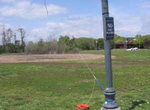 Three parafoils at Savin Rock in West Haven, Connecticut.  The tethered blue one is large enough to require a heavy line and a climbing carbiner.  The red one aloft at upper right is only slightly smaller than the blue one.  Still on the ground and