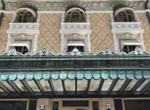 Large 3 story building with ornately carved windows and a large green porch with a stained glass panels that spell out "Fordyce Bath House."
The front of the Fordyce Bathhouse. The building was originally built in 1915 and today serves as the Park's