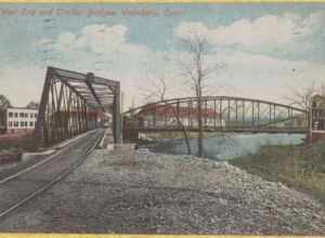 Divided back postcard of the streetcar bridge across the Naugatuck River in Waterbury, postmarked 1913. The line was later rerouted over the West End bridge (West Main Street) in the background.