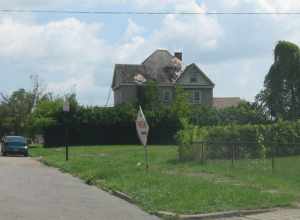 Empty lots and a house on the southern side of the 300 block of Arlington Avenue in Youngstown, Ohio, United States.  The house is part of the Arlington Avenue Historic District, a historic district that is listed on the National Register of Historic