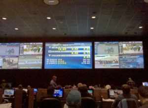 Dover Downs' sports lounge, showing the three main TV which are simulcasting different horse racing tracks