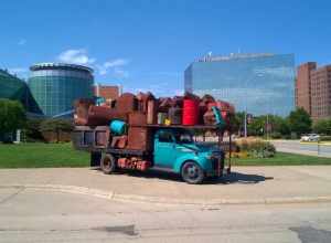 Sioux City Art Museum Featuring John Himmelfarb: Trucks.  Penelope Awaiting Her Chamberlain, 2013, 1946 Chevrolet farm truck and found objects, 11 feet 5 inches x 25 feet x 8 feet 6 inches.