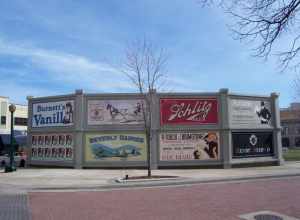 Fake advertisement signs to hide some modern benches in the city square.