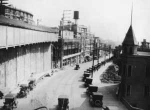 Similar view 12 years earlier.
Western Avenue on the west side of Pike Place Market, Seattle, Washington, 1921. File:Seattle - map - Pike Place Market and vicinity 1920.jpg shows that this neighborhood had a different configuration of streets then