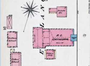 An 1884 Sanborn Fire Insurance Map cropped to show the property of St. Raphael's Cathedral in Dubuque, Iowa, United States. The cathedral is in the center (pink, tower in blue). The rectory is located immediately to the north of the cathedral and