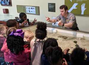 A man in a uniform gestures with children, who make the same signs back to him.
Assateague Island National Seashore: Connecting with the next generation will help protect our oceans and beaches.
Keywords: 2019 Region 1