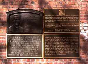 Looking west at plaques on wall of Playhouse on a sunny morning.