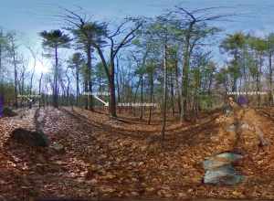 360 panoramic image of a wooded area on elevated ground looking toward a lower area. Text and image enhancements include, to the left, a blue rectangle and white text that says Lexington left flank. To the right of that white text says Rocky Outcrop