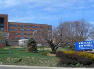 Looking west at the hospital entrance on a sunny midday.