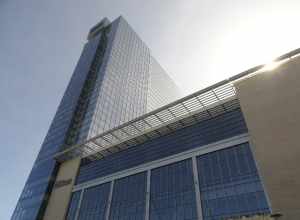 The glassy, modern Hilton Cleveland Downtown [Convention Center] Hotel (HCDH) on a bright, warm day; perspective looking up from Ontario Street and Lakeside Avenue in downtown Cleveland, Ohio.