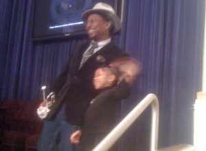 Musician Kermit Ruffins and child at New Orleans City Council Chambers