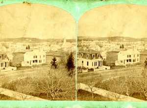 SV-374 — Nelson Dionne Collection. Aerial view looking north toward Western Ave in Lynn, Mass., in the direction of Flax Pond. On the left is the Lydia E. Pinkham House (both it and the home to the right on Western Ave. are extant). The view appears
