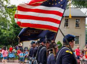 2nd Rhode Island Volunteers Co. B Reenactors carry a 34-star flag. 2023 Gaspee Days Parade, Pawtuxet Village, Rhode Island.