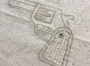 Shannon Downey aka Badass Cross Stitch created several dozen fiber-based guns and launched a global craftivism project around gun violence. The project featured over 200 fiber-based guns created and submitted from artists around the world. There was