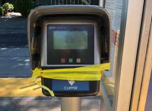 A Clipper card validation machine wrapped in yellow caution tape at the Japantown/Ayer station in San Jose, California, in June 2021. The entire VTA light rail system was suspended indefinitely following a mass shooting at the VTA light rail yard in