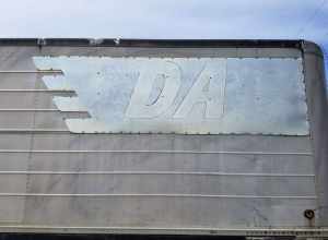 Sign on trailer, "DA, Denver Albuquerque Motor Transport, Denver, Colo.", parked in Adams County, CO.
