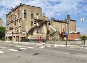 Built in 1890, this Richardsonian Romanesque Revival-style building was designed by Samuel Hannaford for Paul J. Sorg to serve as an opera house.  The building features a brick exterior with a rough-hewn stone front facade, arched window bays on the