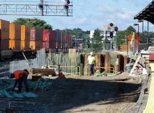 Construction work on the tunnel to the new second platform at Worcester Union Station in September 2022. At left, a CSX freight train passes.