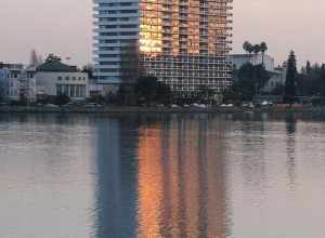 Lake Merritt high rise with its windows a blaze across the lake