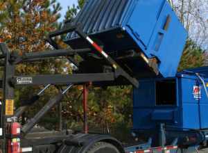 A blue Allied Waste Services dumpster lifted on top of an International truck in Durham, North Carolina.