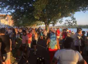 People walking and waiting in line for food trucks on Riverfront Park in Harrisburg, PA, for "July 4th Food Trucks &amp; Fireworks" in 2021