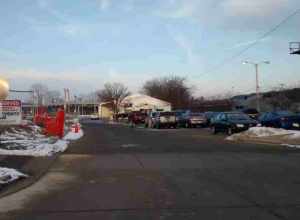 Old East Lansing Amtrak Station in front of the newly build multimodal Amtrak Station. The last train to leave the station is to the right of the station on January 25, 2016