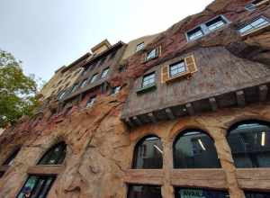 The fake stone is plaster over metal wire,rebar, and metal stud frame.  Upper floors are stucco.